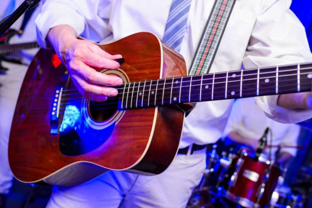 acoustic guitar on performance in hands
