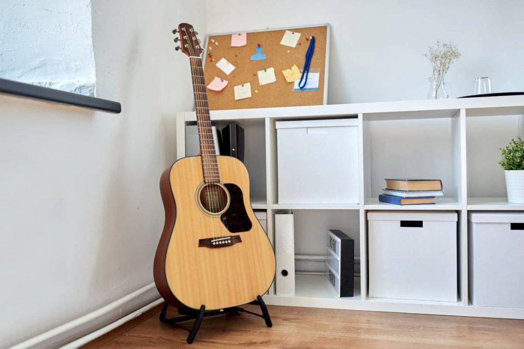 acoustic guitar on stand at home