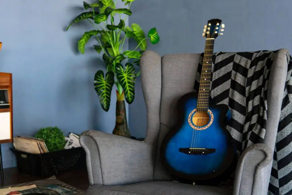 comfortable armchair and guitar in room