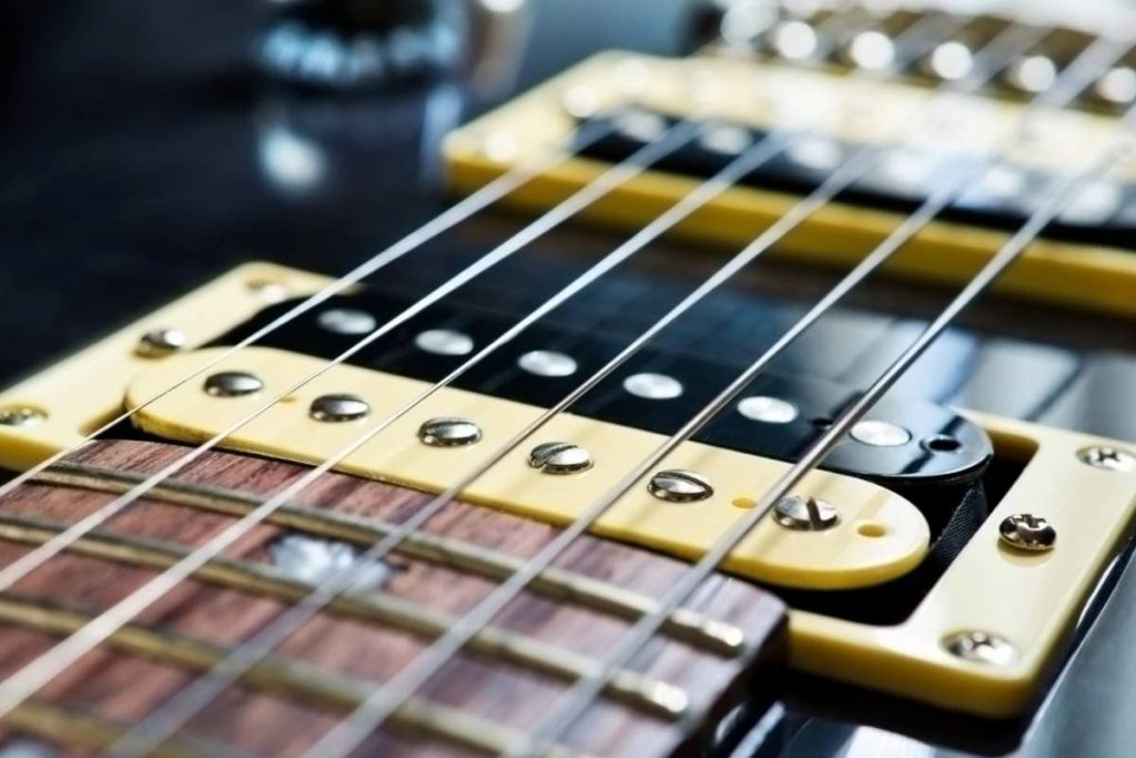 detail of sixstring electric guitar and pickups