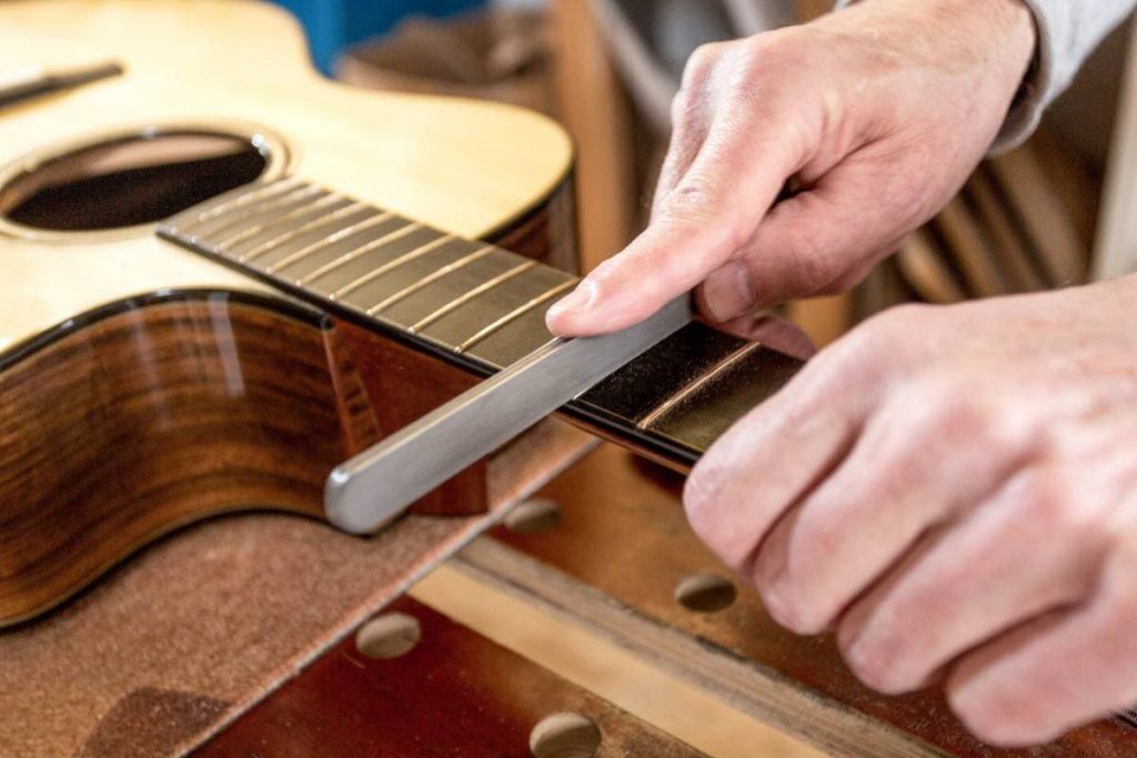 filing the frets of an acoustic guitar