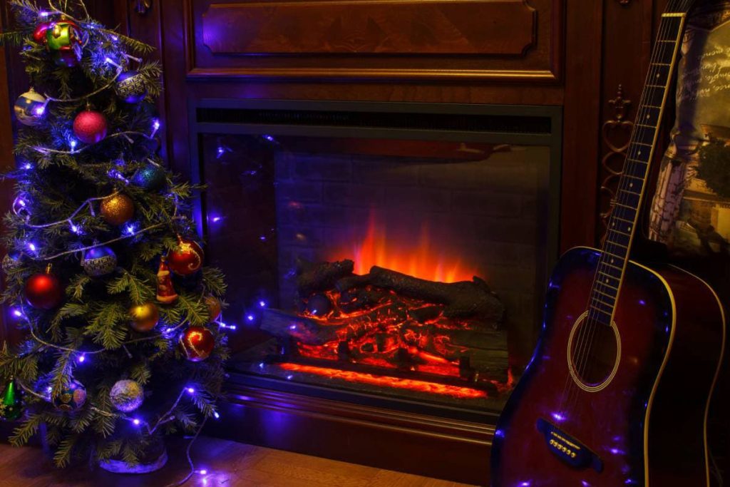 fireplace christmas tree and guitar