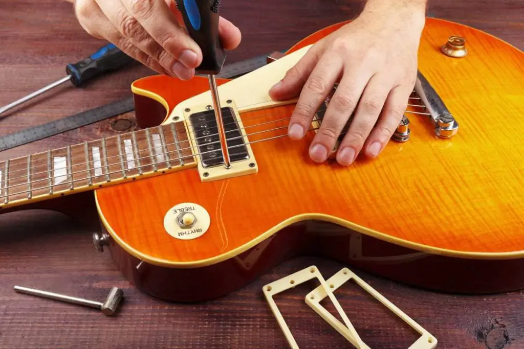 guitar technician tune the height pickups