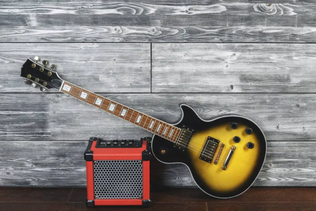 guitar with amplifier in wooden interior