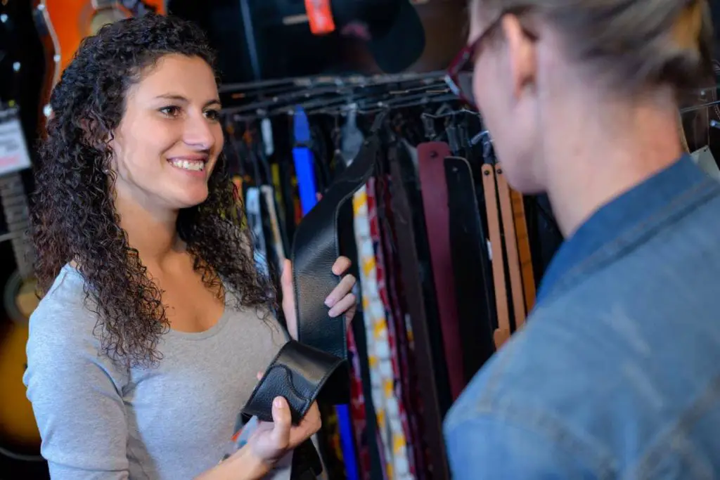 lady looking at strap in music shop