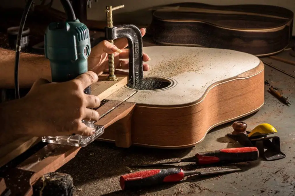 luthier making an acoustic guitar