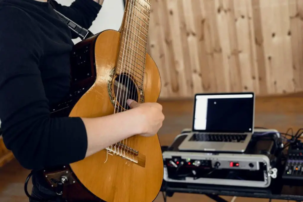 male guitarist checking sound equipment