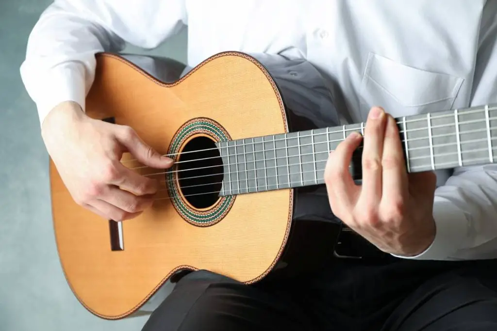 man playing on classic guitar