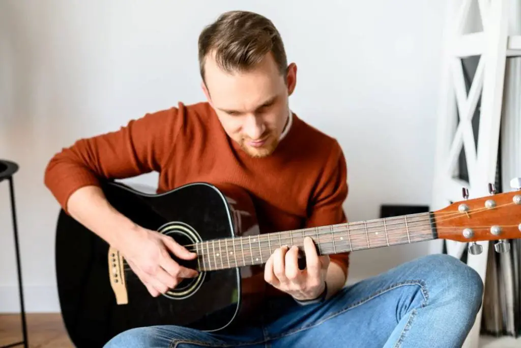 playing music with an acoustic guitar