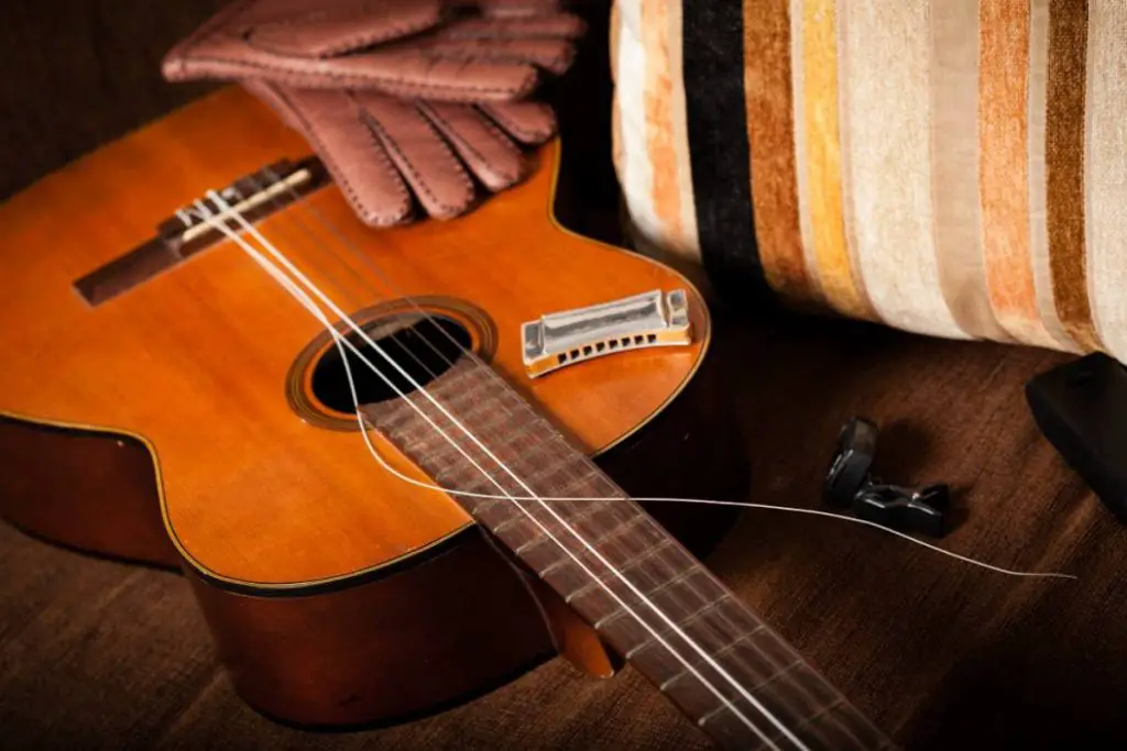 vintage classical guitar with broken string