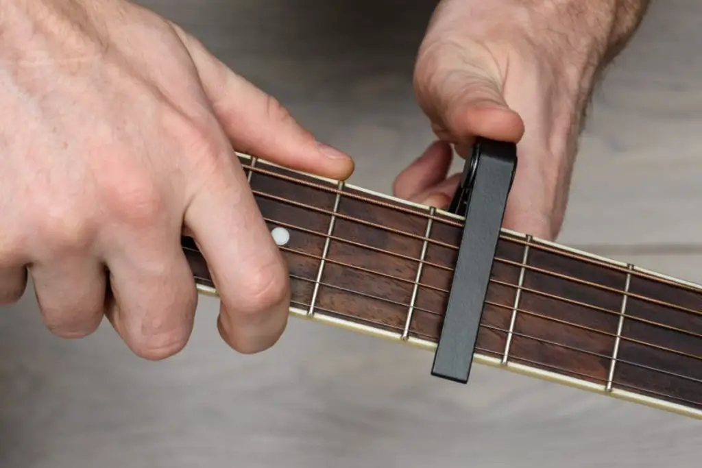 guitar capos lower the action of the strings