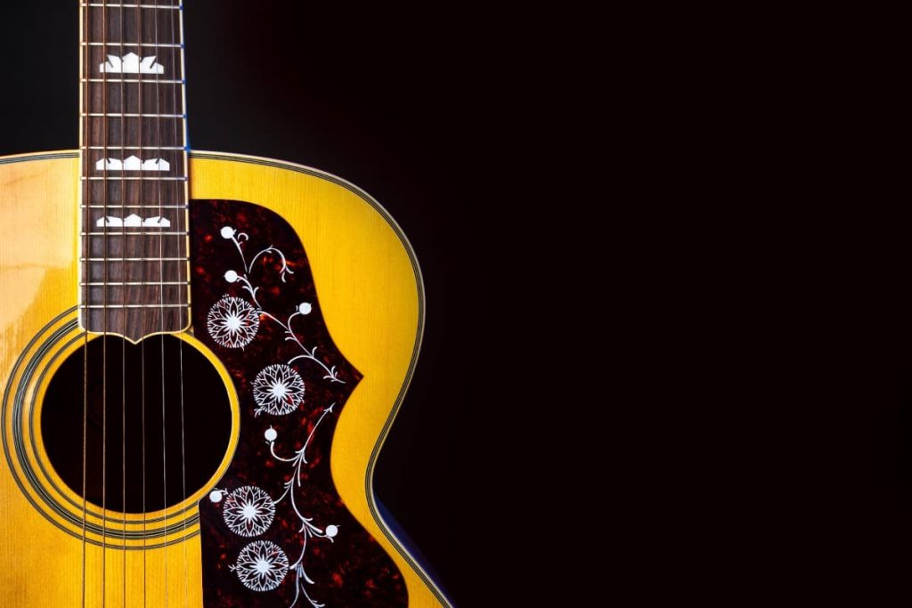 pickguard affect the tone of an acoustic guitar