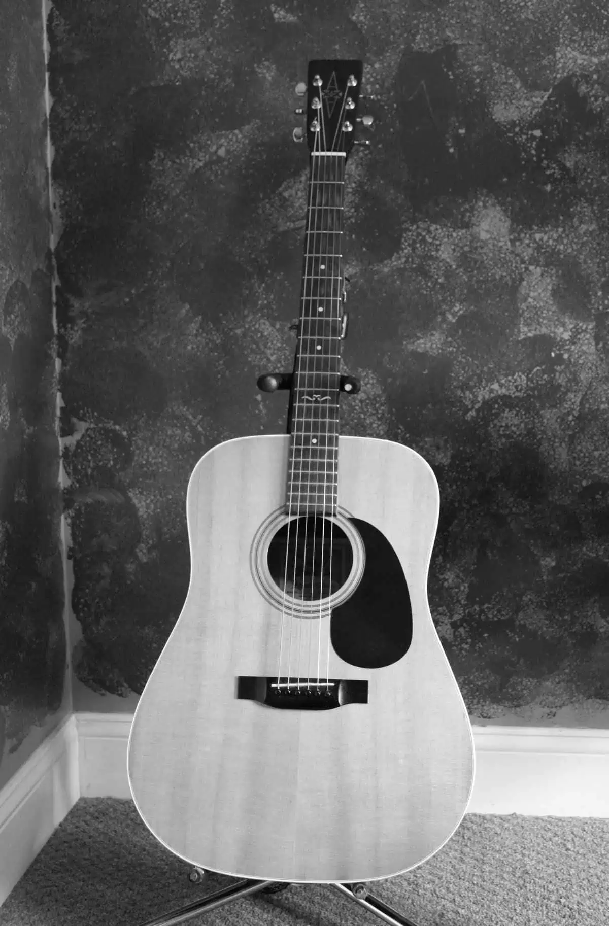 Acoustic guitar on a stand, one of the best acoustic guitars for classic design
