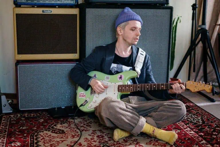Best Guitar Audio Interfaces 2026 for Home Recording 3 Guitarist recording at home with the best audio interface for guitar setup