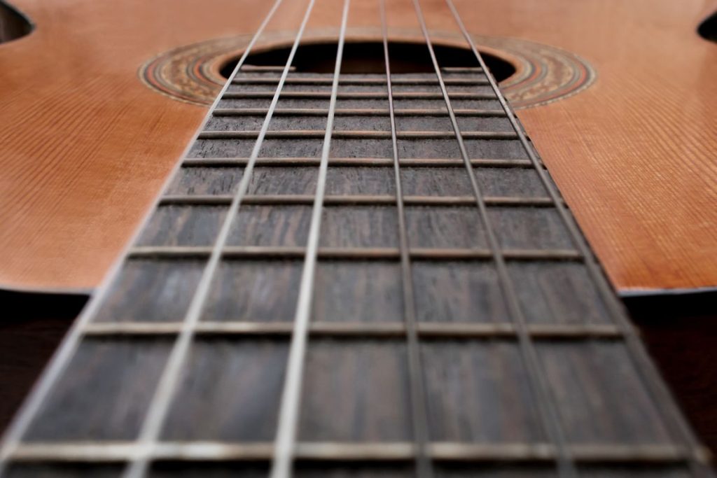 Music theory for guitar beginners: hands forming a chord on the fretboard