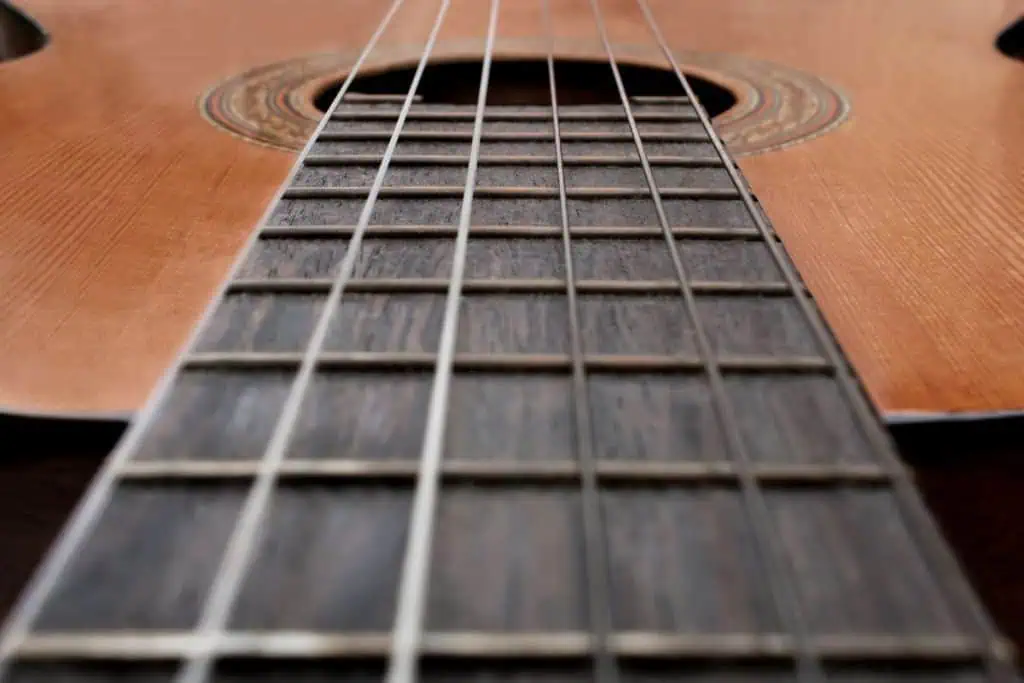 Music Theory for Guitar: The Complete Beginner's Guide 2026 1 Music theory for guitar beginners: hands forming a chord on the fretboard