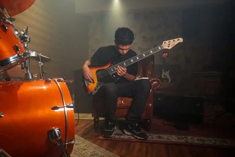 How to Write Lyrics for Suno: Brackets, Meta Tags & Song Structure 2 Bassist practicing in a studio, comparing short scale vs long scale bass