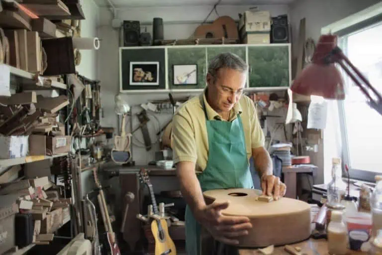 Best Glue for Guitar Building: Which Glue Is the Best to Use? (5 Compared) 1 Craftsman in a workshop choosing the best glue for guitar building