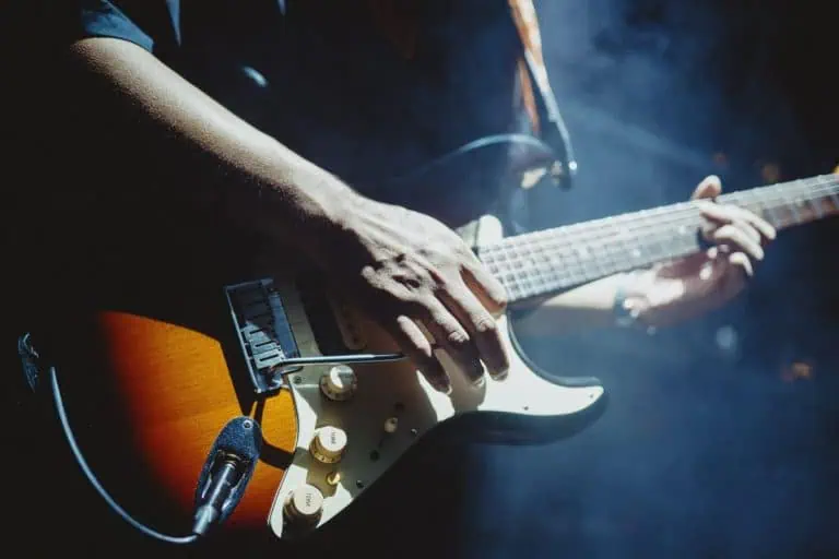 Best Guitar Riffs of All Time: 20 Legendary Riffs Every Guitarist Should Learn 1 Electric guitarist on stage playing one of the best guitar riffs of all time