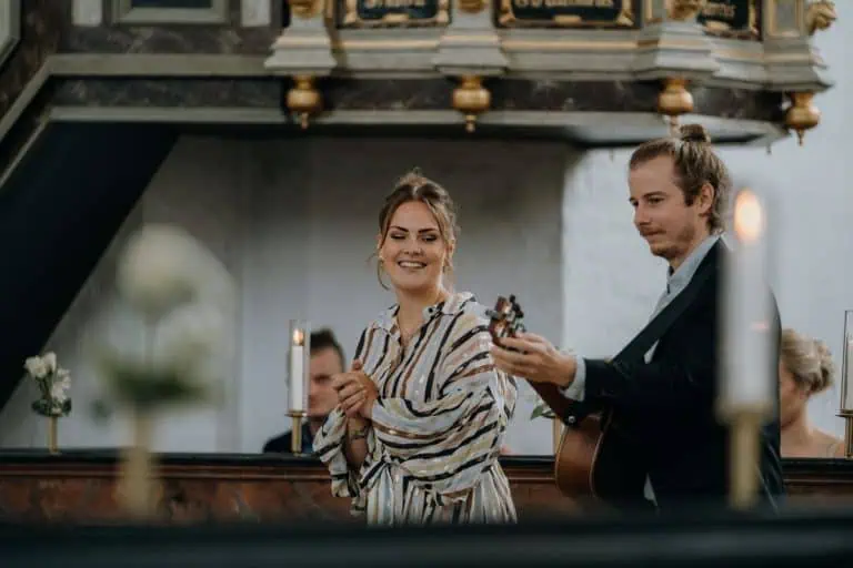 Acoustic duo playing hymns on guitar during a church service