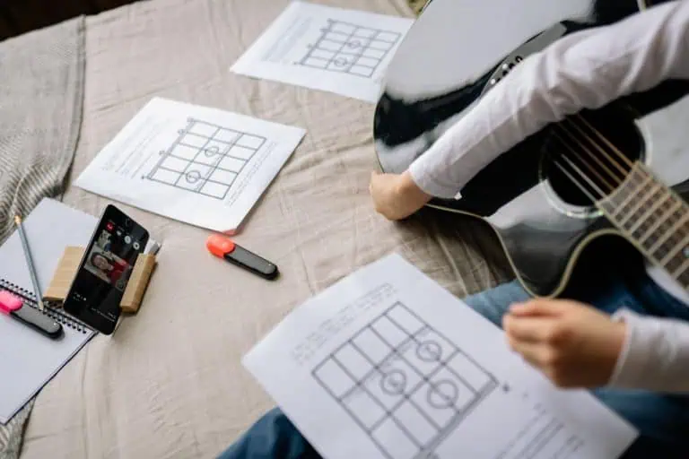 Worship Chord Progressions: 1-5-6-4 and 8 Others Every Worship Writer Uses 1 Guitarist reading a worship chord chart - worship chord progressions